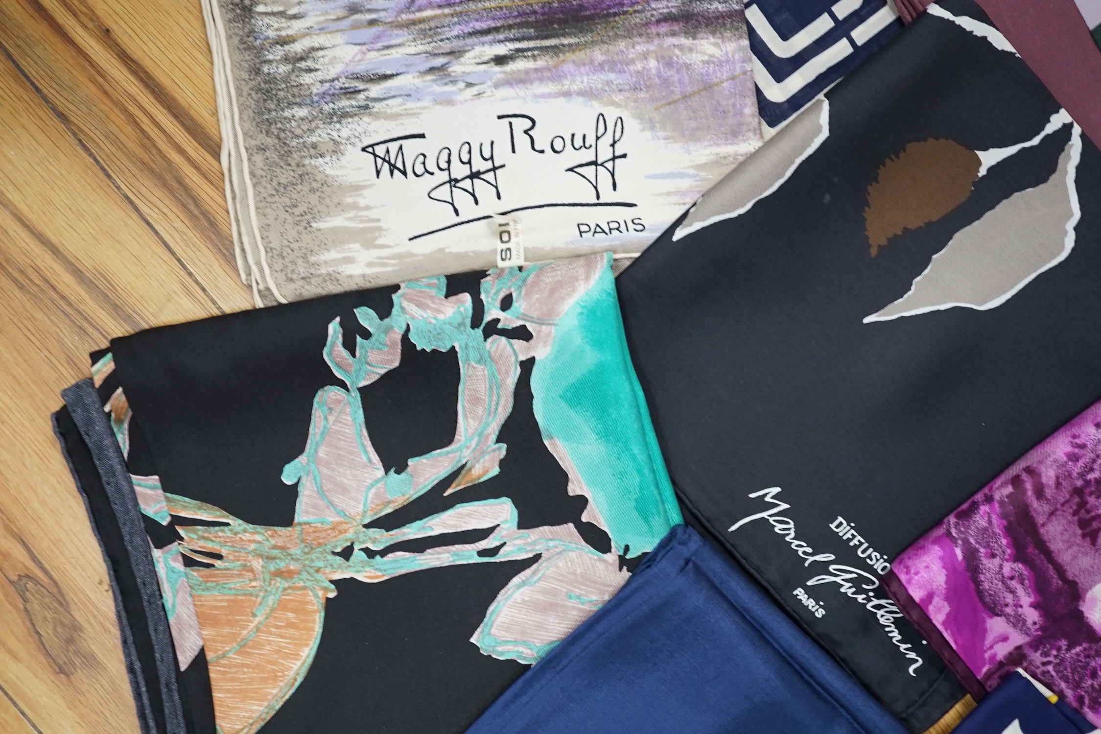 A collection of vintage silk scarves including Lanvin, Yves Saint Laurent, Maggy Rouff and one retailed by Harrods